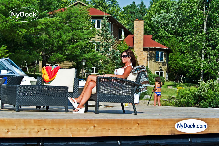 Woman sitting in lounge chair on a NyDock floating dock