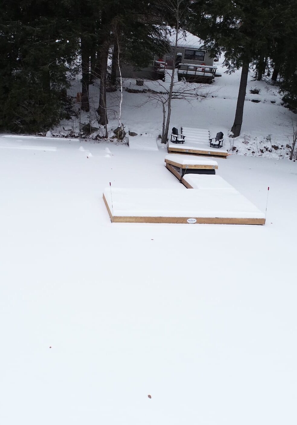 Cottage with NyDock on frozen lake.